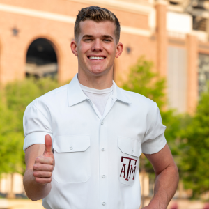 Yell Leader Jake giving a gig 'em and smiling at the camera.