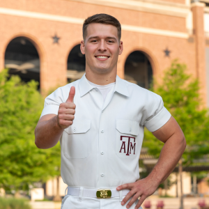 Yell Leader Trevor giving a gig 'em and smiling at the camera.